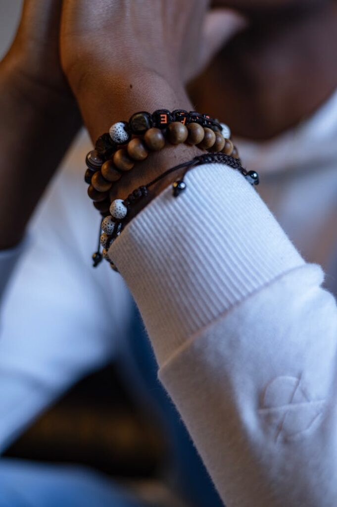 pexels-photo-7327178 Close-up shot of beaded bracelets on a person's wrist in a relaxed setting.